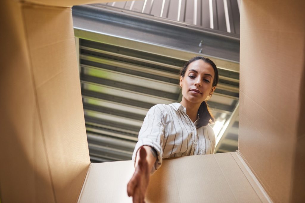 woman-opening-box-in-storage-unit
