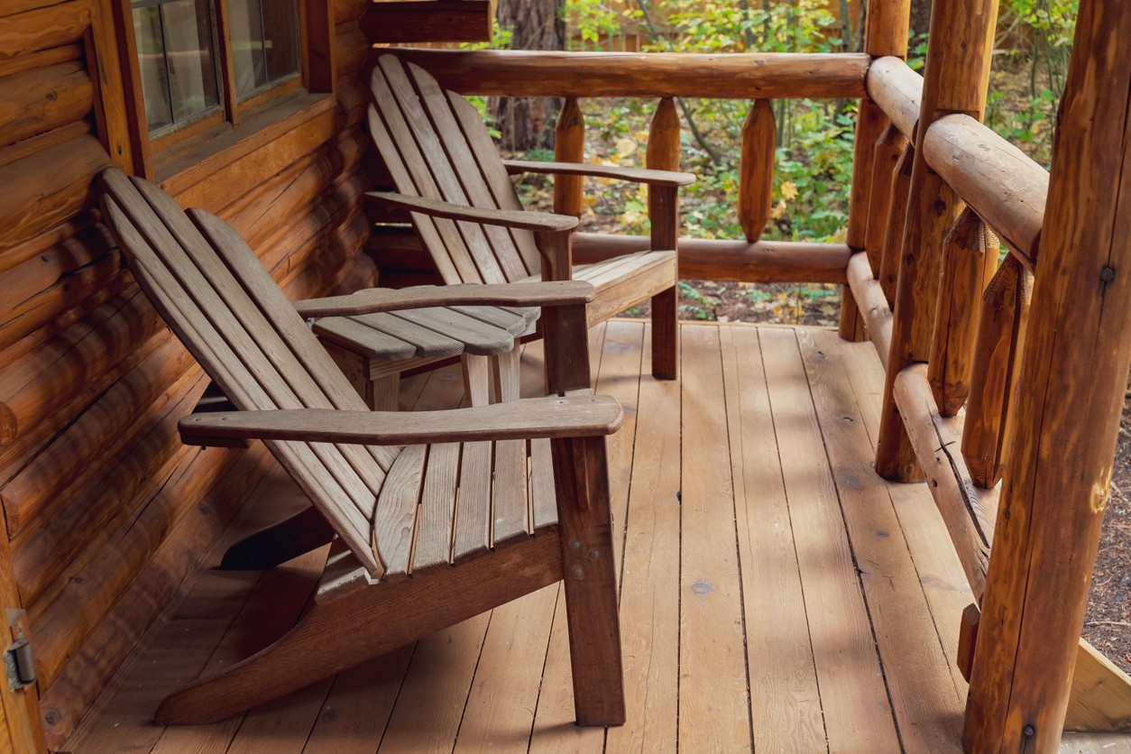 two-adirondack-chairs-on-cabin-porch