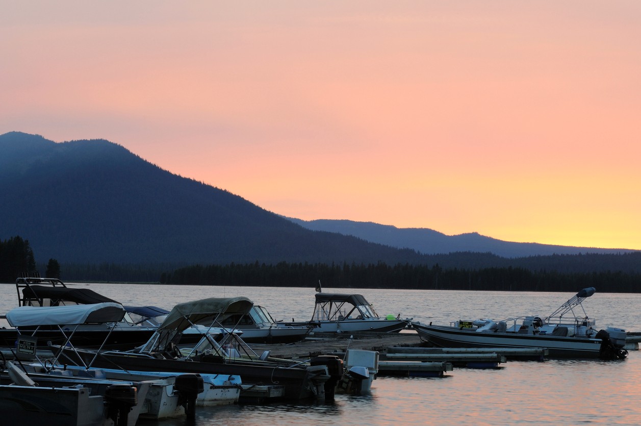Boats at the dock at sunset on Crain Prairie Reservoir in Bend, Oregon. 