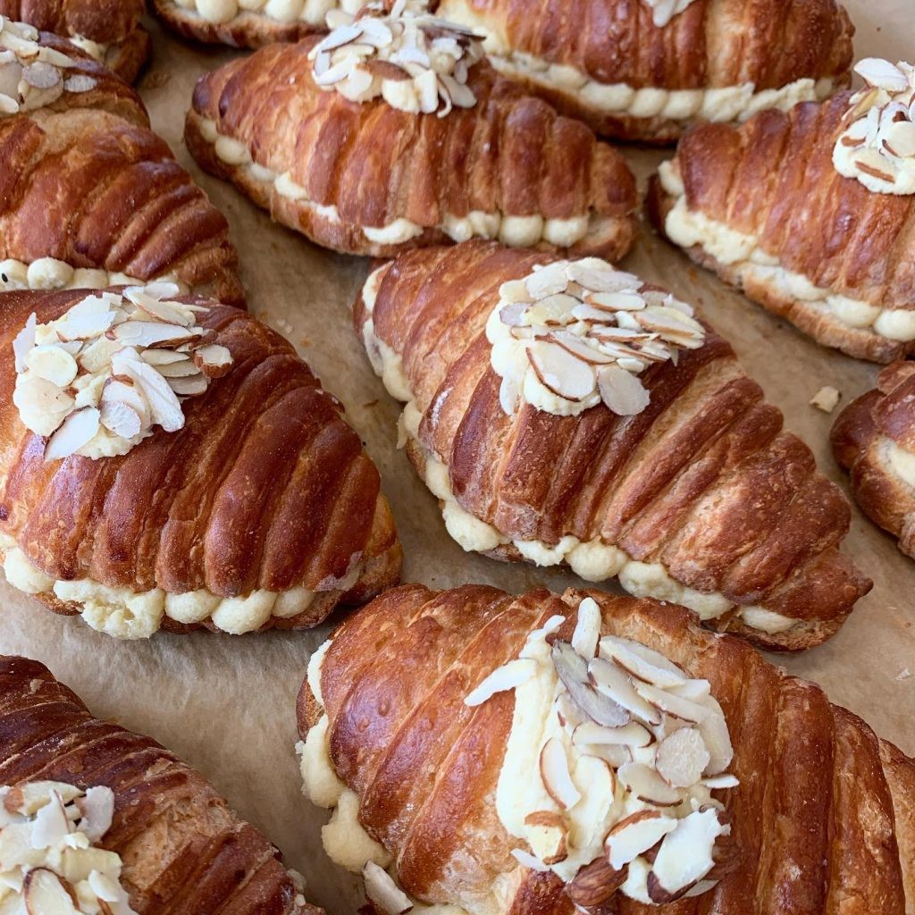 Close up view of rows of almond croissants at the Sparrow Bakery in Bend, Oregon. 